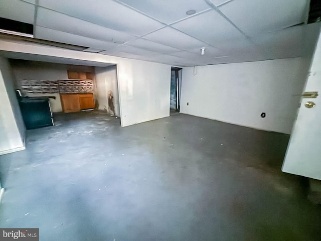 finished basement with a paneled ceiling