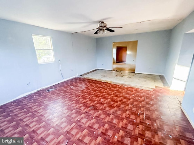 unfurnished room featuring parquet flooring and ceiling fan