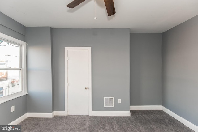 carpeted empty room featuring ceiling fan