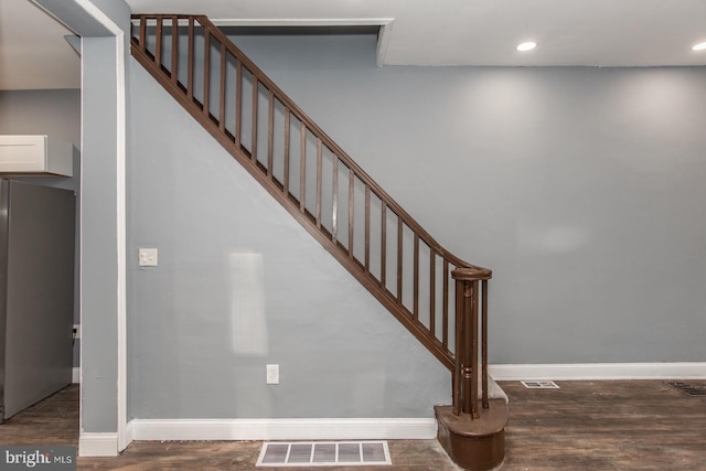 staircase featuring wood-type flooring