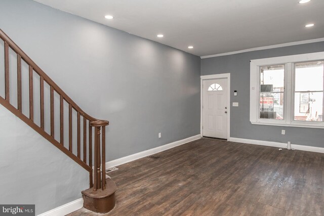 entryway with crown molding and dark hardwood / wood-style flooring