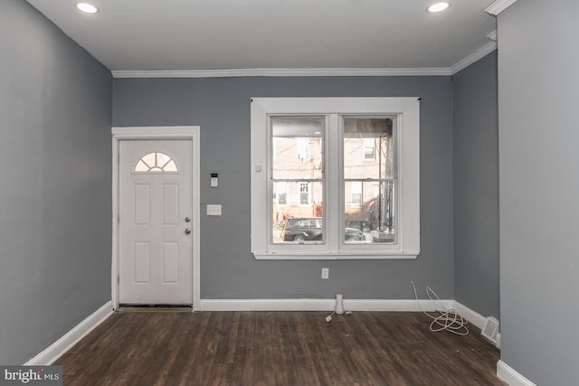 entryway with dark hardwood / wood-style flooring and crown molding