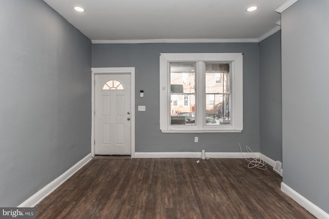 foyer featuring dark wood-type flooring and crown molding