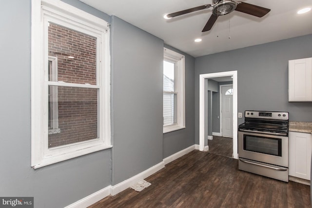 kitchen with white cabinets, stainless steel electric range oven, dark wood-type flooring, and ceiling fan