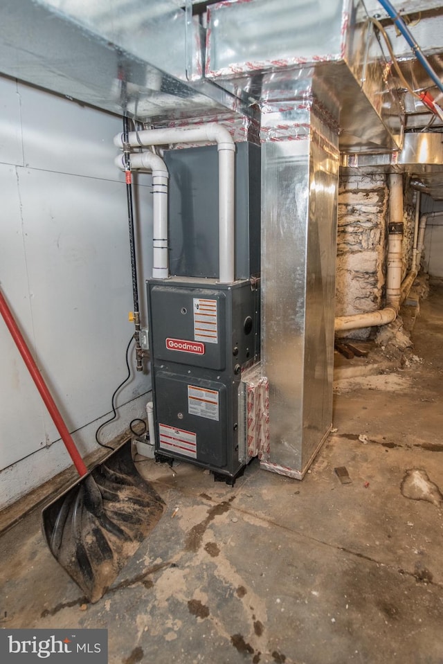 utility room featuring heating unit