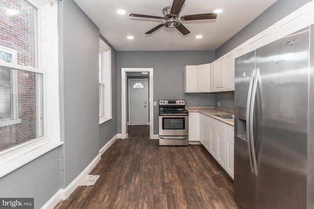 kitchen featuring dark hardwood / wood-style floors, white cabinetry, and appliances with stainless steel finishes