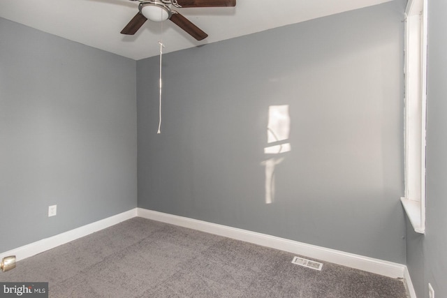 carpeted spare room featuring ceiling fan