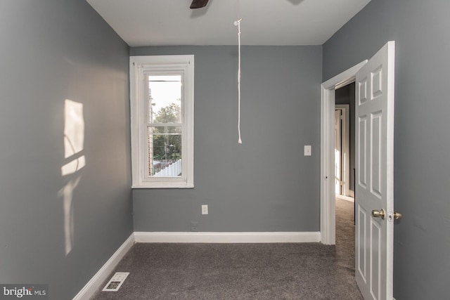 carpeted empty room featuring ceiling fan