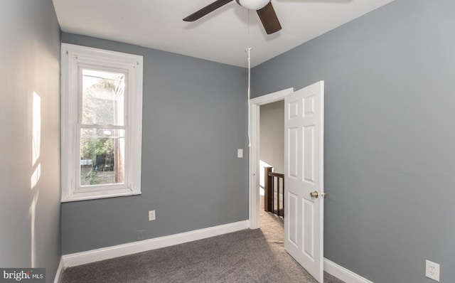 empty room featuring carpet and ceiling fan