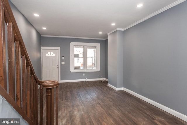 entrance foyer featuring ornamental molding and dark hardwood / wood-style floors