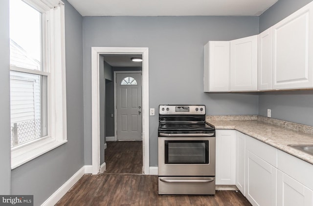 kitchen featuring white cabinets, dark hardwood / wood-style floors, and stainless steel electric stove