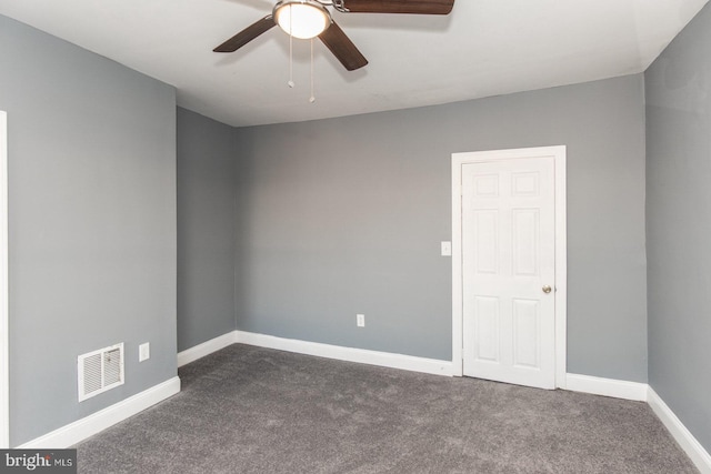 carpeted spare room featuring ceiling fan