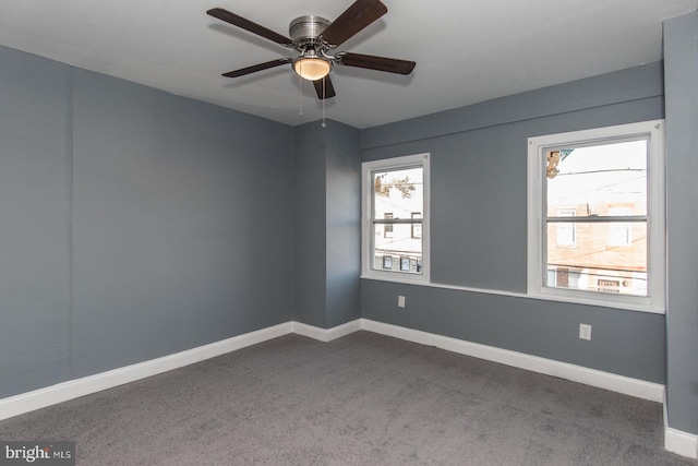 empty room with ceiling fan and carpet flooring