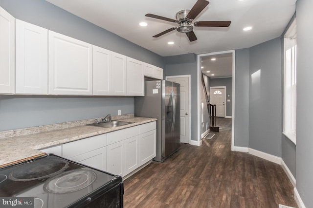 kitchen with white cabinetry, black electric range oven, dark wood-type flooring, and sink