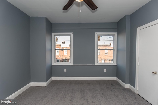 empty room with ceiling fan, plenty of natural light, and carpet