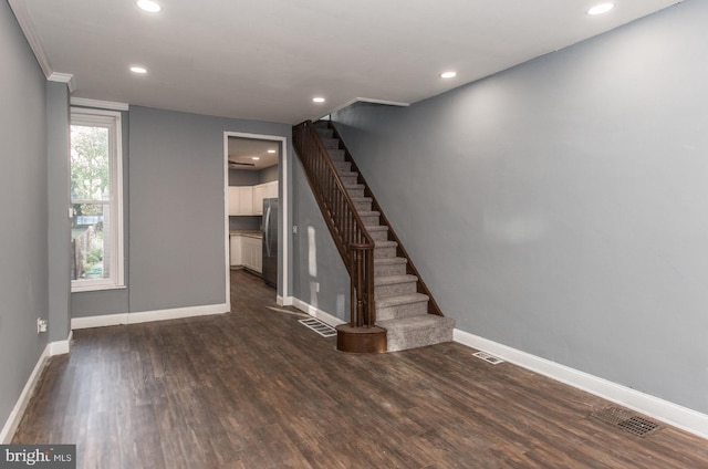 interior space featuring dark hardwood / wood-style floors and crown molding