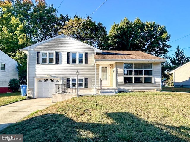 tri-level home with a garage and a front yard