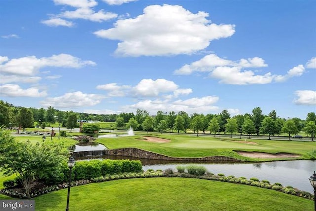 view of community with a yard and a water view