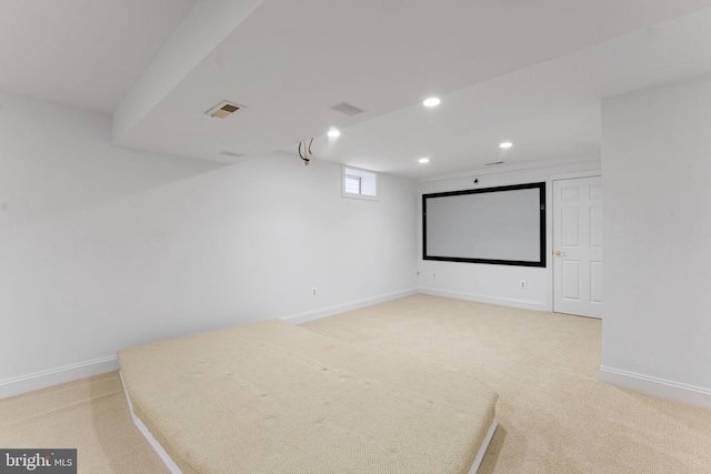 cinema room featuring light carpet