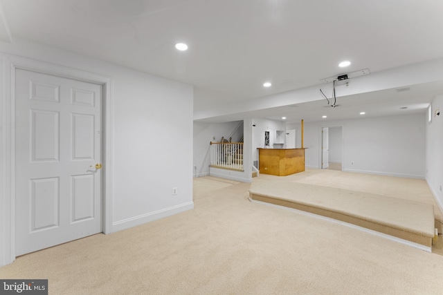 basement featuring light colored carpet