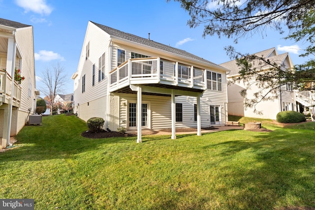 rear view of property with central AC unit, a lawn, a wooden deck, and a patio