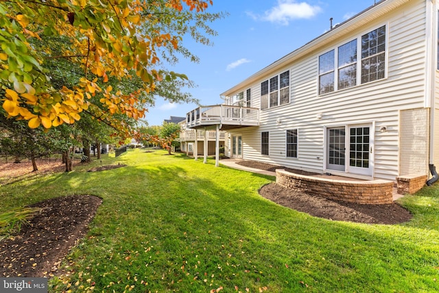 back of property with a patio and a yard