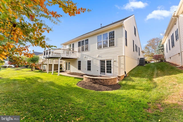 back of property with cooling unit, a lawn, a patio, and a deck