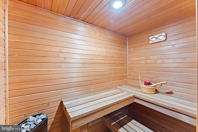 view of sauna featuring wooden walls and wooden ceiling