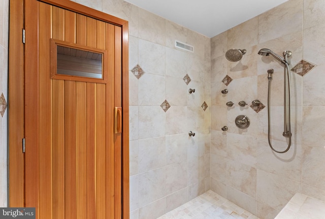 bathroom with tiled shower