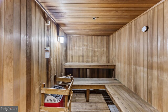 view of sauna / steam room featuring wood ceiling and wooden walls