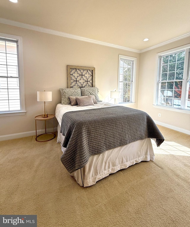 carpeted bedroom featuring multiple windows and crown molding