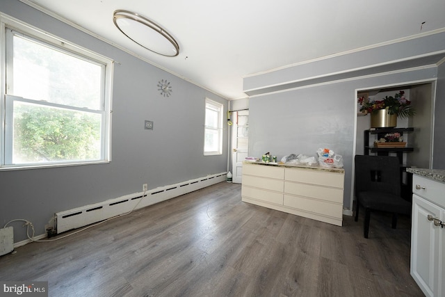 dining space with a baseboard heating unit and hardwood / wood-style floors