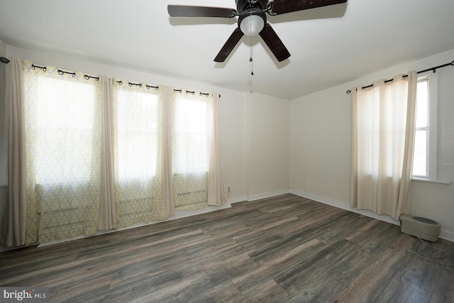 spare room featuring dark hardwood / wood-style floors and ceiling fan