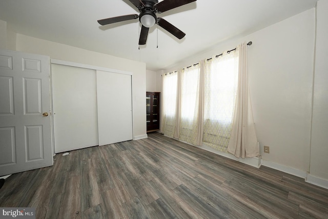 unfurnished bedroom featuring a closet, ceiling fan, and dark hardwood / wood-style floors