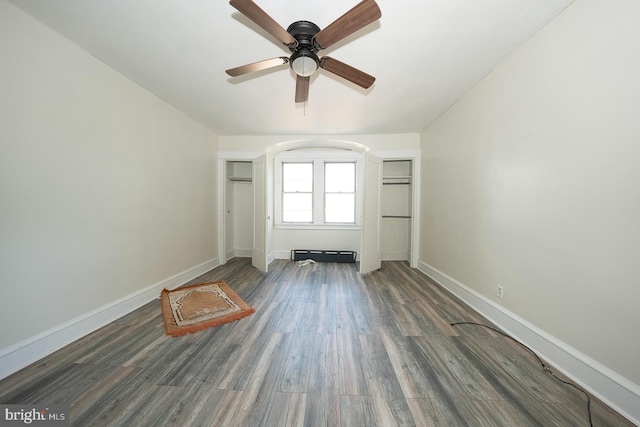 empty room with dark wood-type flooring and ceiling fan