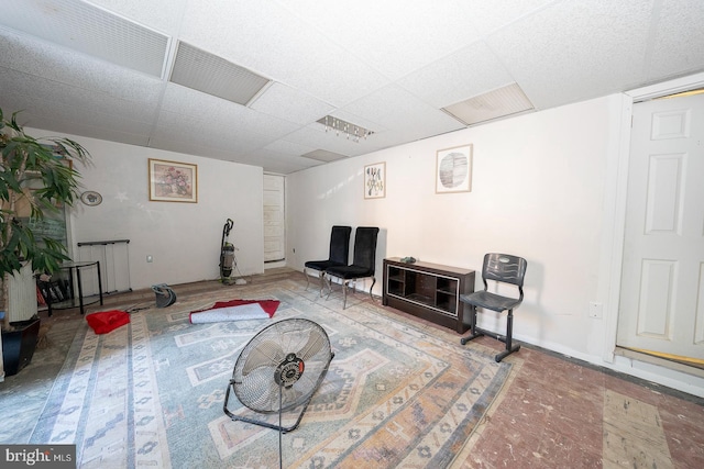 living area featuring a drop ceiling