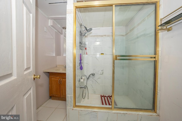 bathroom featuring a shower with door, vanity, and tile patterned floors