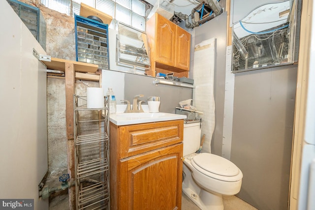 bathroom featuring toilet and vanity