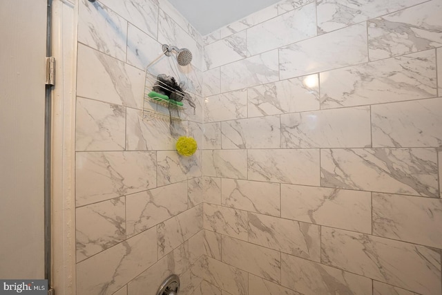 bathroom with tiled shower