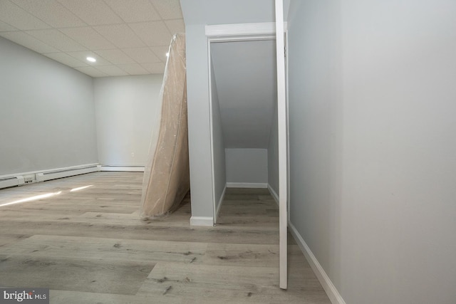 interior space featuring hardwood / wood-style flooring and a drop ceiling