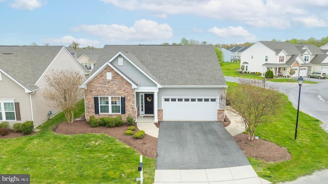 view of front of home with a front yard and a garage