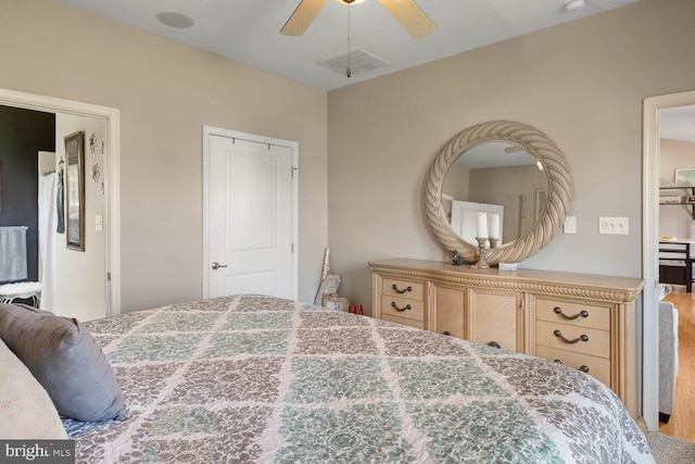 bedroom with ceiling fan and hardwood / wood-style flooring