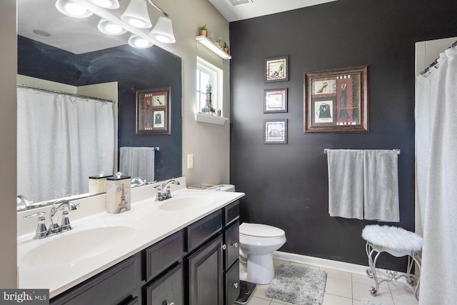 bathroom featuring vanity, toilet, and tile patterned flooring