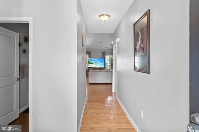 hallway with light hardwood / wood-style flooring