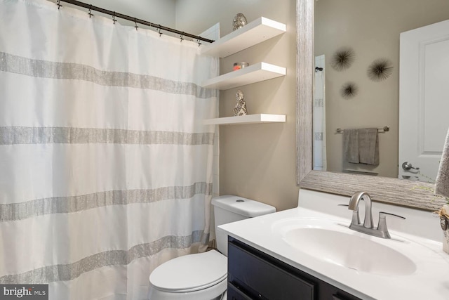 bathroom featuring vanity, toilet, and a shower with shower curtain