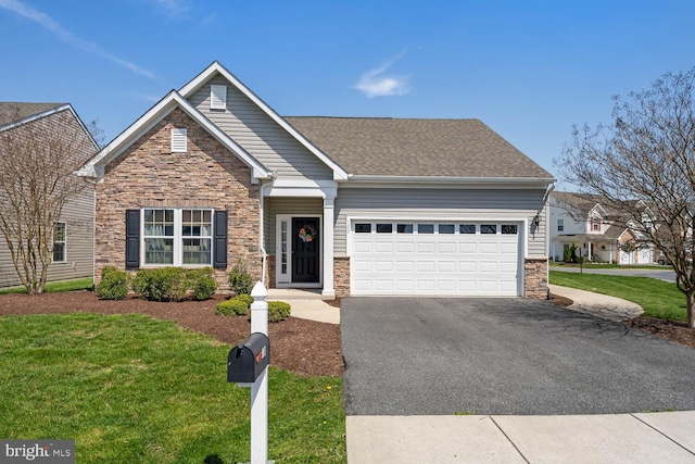 view of front of property featuring a front lawn and a garage