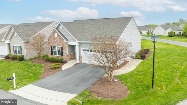 view of front of house with a front yard and a garage