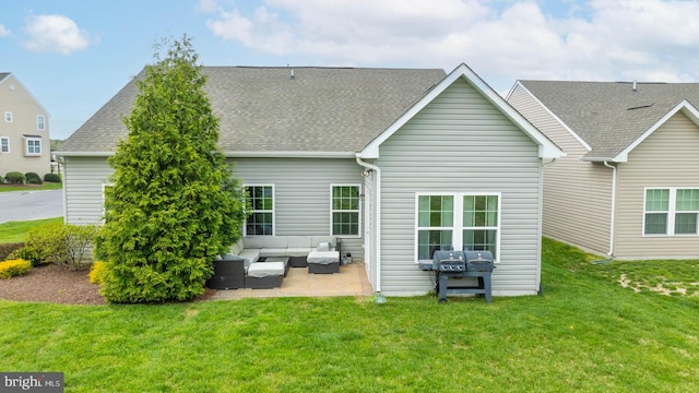 back of property featuring a yard, an outdoor living space, and a patio