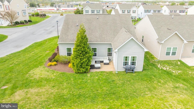 back of property with a patio, a yard, and an outdoor hangout area