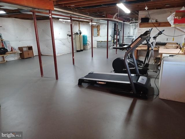 workout area featuring electric panel and concrete floors